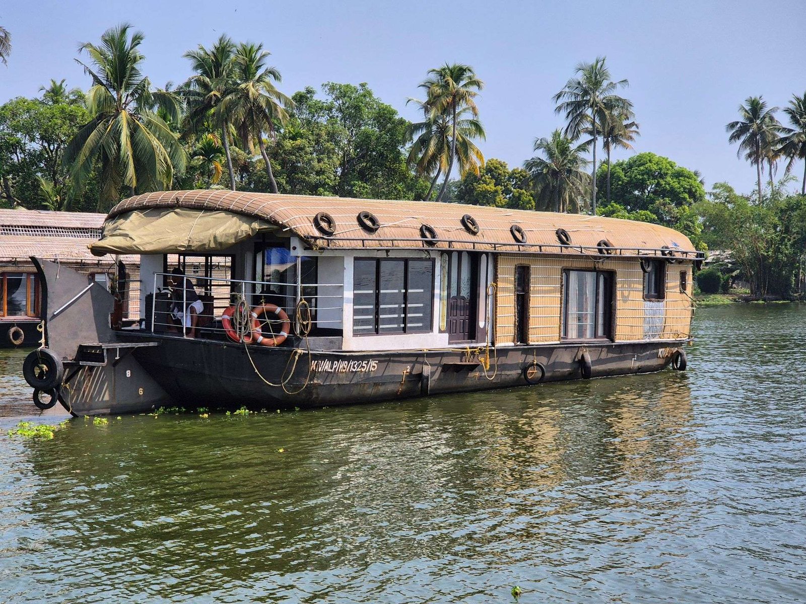 Backwater Bliss 1 bedroom private houseboat moored among coconut palms in Alleppey