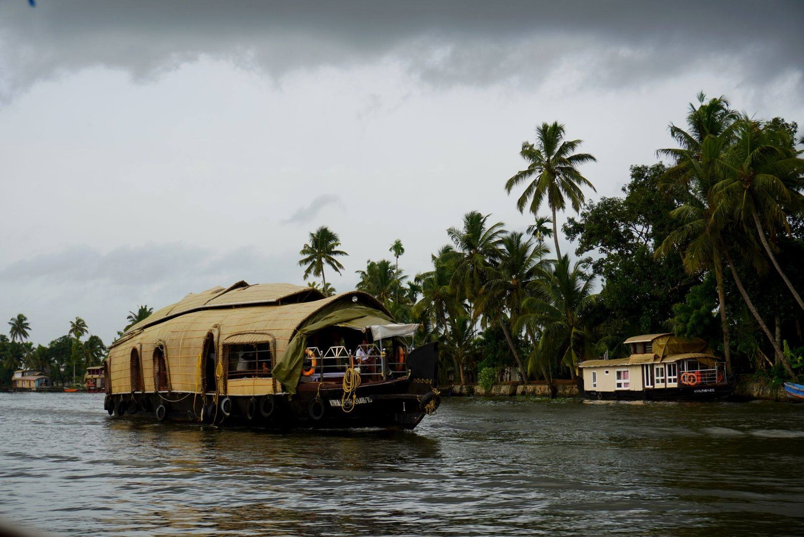 Pamba Breeze premium 2 bedroom houseboat cruising the Alleppey backwaters under monsoon clouds