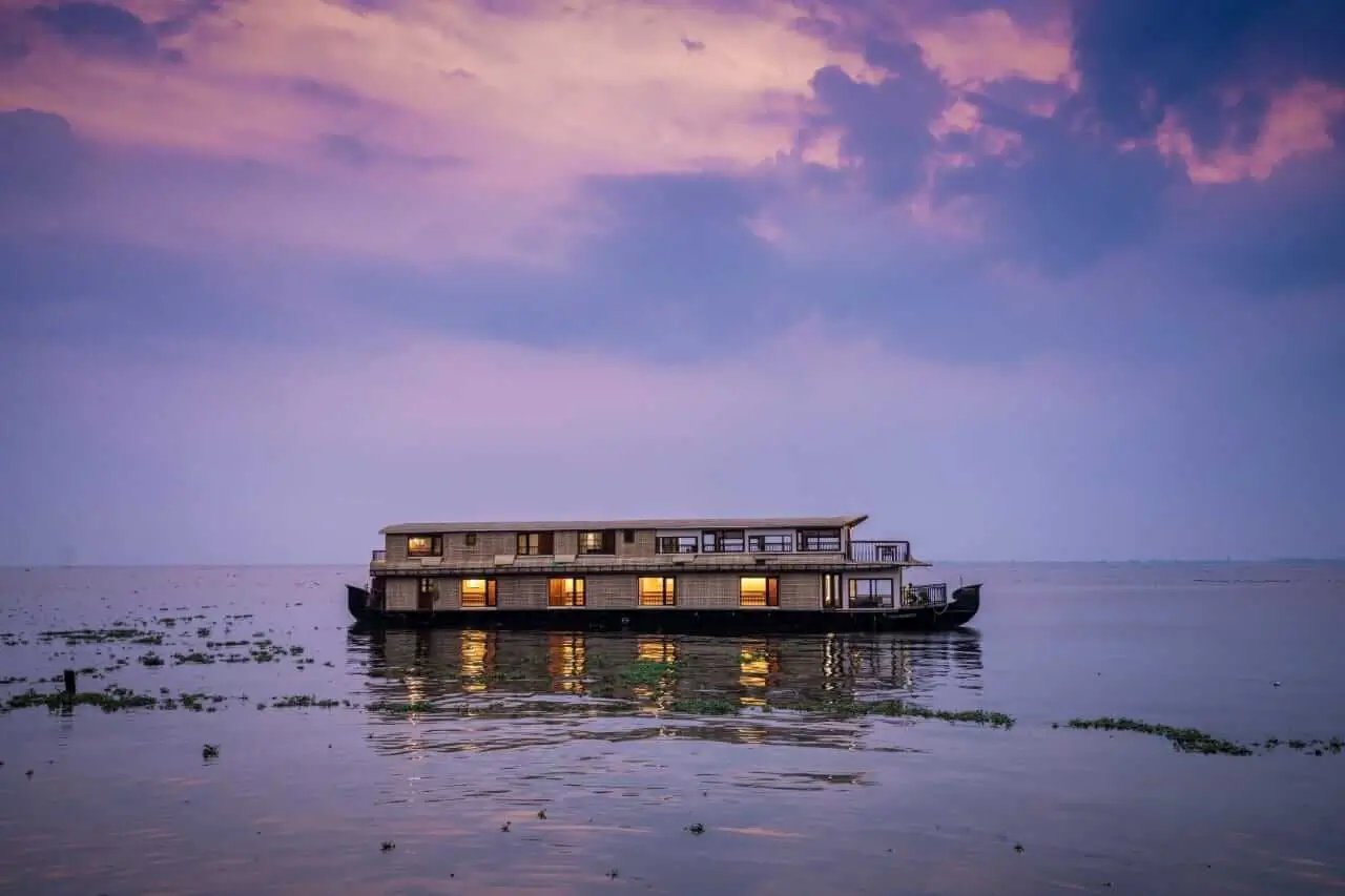 Punnamada Pradeepam premium 8 bedroom double-deck houseboat on Vembanad Lake at dusk