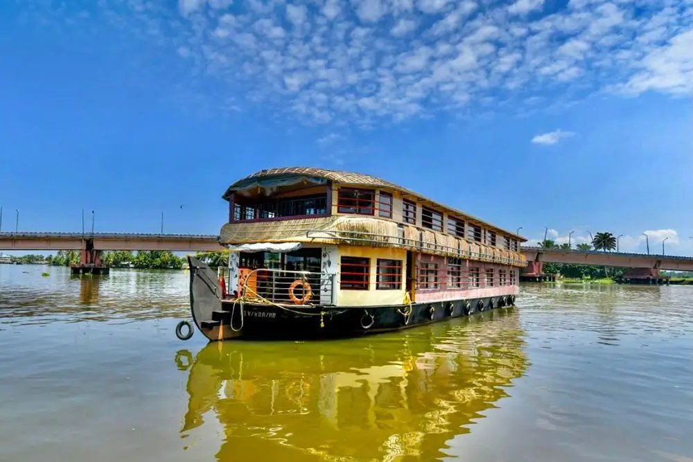 Kuttanad Kalyani deluxe 9 bedroom double-deck houseboat on a sunny Alleppey river